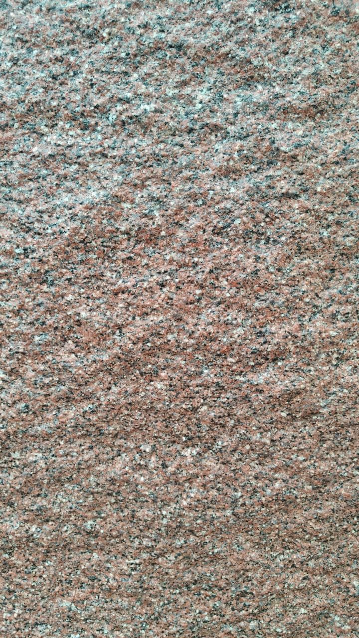 Rough Queen Rose granite block at the quarry